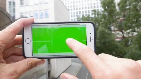 Personal perspective of a man using a smartphone with a green-screen Video stock 104116204