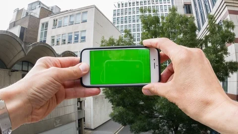Personal perspective of a man using a smartphone with a green-screen Video stock 104116845