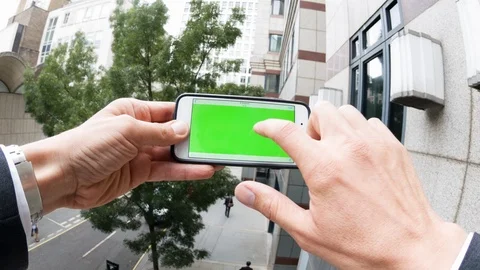 Personal perspective of a man using a smartphone with a green-screen Video stock 104117714
