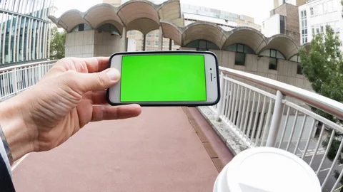 Personal perspective of a man using a smartphone with a green-screen Stock-Footage 104118165