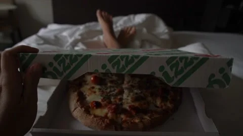Personal perspective opening take away pizza box in bed Stock Footage 143691300