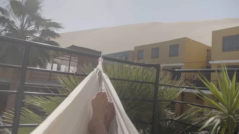 Personal perspective view of a man swinging in the hammock Stock Footage 125273502