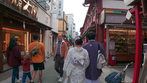 Personal perspective of walking down a busy in Asakusa, Tokyo Stock Footage 329925182