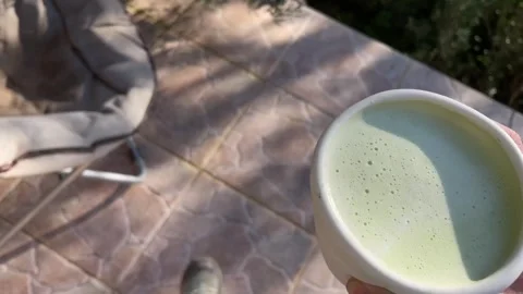 Personal perspective walking outside the house with matcha latte Stock Footage 293164055