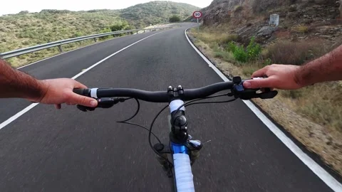 Personal Point of view of a cyclist speeding down a road. Concept: cycling Stock Footage 169455203