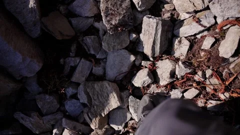 Personal point of view shot of a hiker's boot stepping carefully across loose Vídeos de archivo 344177385