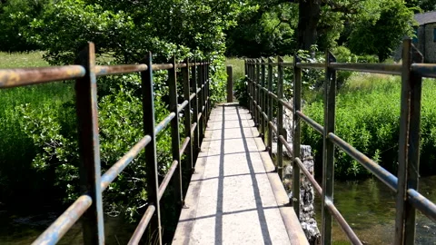 Personal point of view walking on bridge over small river Vídeos de archivo 199283926