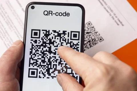 Personal QR code of vaccination from coronavirus on smartphone in human hand 스톡 사진