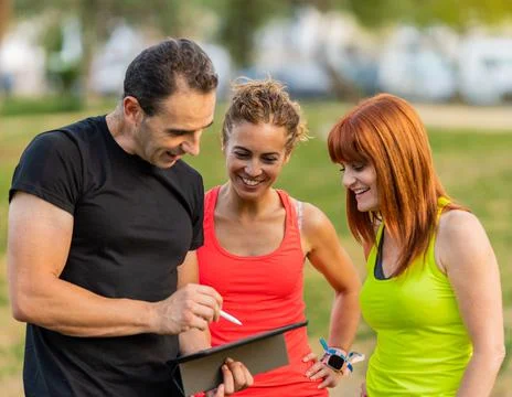 Personal Trainer Explaining Workout Stock Photos