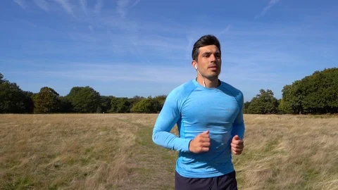 Personal Trainer Jogging in Park, in Slow Motion Stock Footage 96047342