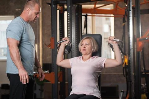 Personal trainer man corrects instructions Stock Photos