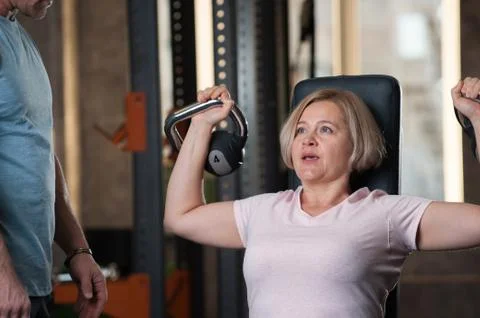 Personal trainer man corrects instructions Stock Photos