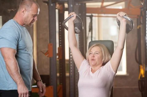 Personal trainer man corrects instructions Stock Photos