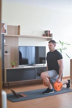 Personal trainer men doing split squads exercises for a lesson at home 스톡 사진