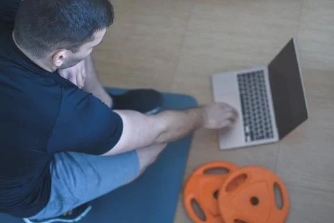 Personal trainer men using a pc for a lesson at home Stock Photos