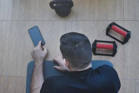 Personal trainer men using a phone for a lesson at home 스톡 사진