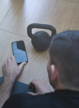 Personal trainer men using a phone for a lesson at home 스톡 사진