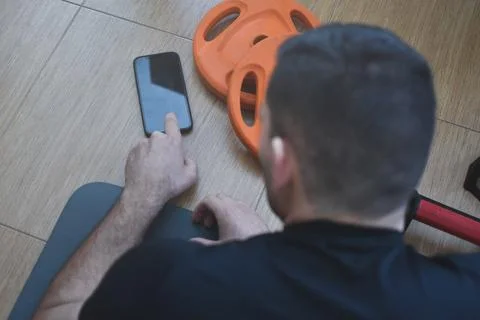 Personal trainer men using a phone for a lesson at home 스톡 사진