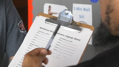 Personal Trainer Orientation With Client at Gym Closeup on Clipboard Stock Footage 125587942