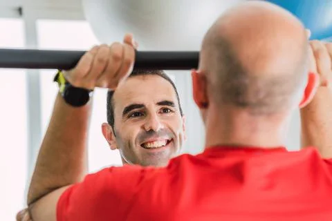 Personal trainer smiling in front of a client Stock Photos