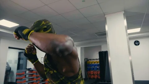 Personal trainer sparring and shadow boxing to camera, action shot slow mo Stock Footage 89577592