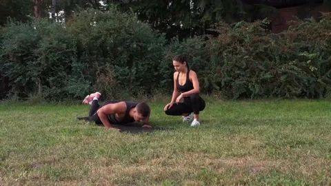 Personal trainer training man pushups. Fitness man training push up exercise Stock Footage 141056608