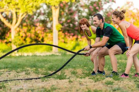 Personal Trainer Using Battle Rope Stock Photos
