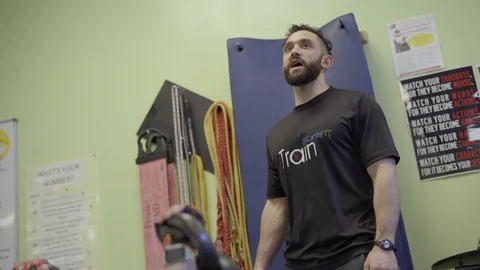 Personal trainer working with female client on bench Stock Footage 73180468