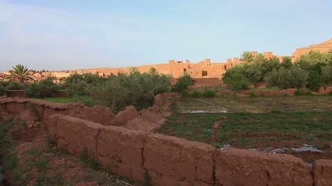 Personal view of walking in African desert scenic city close to water oasis. Video stock 85456272