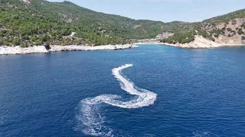 Personal Watercraft Creating Curved Wake in Blue Sea Stock Footage 340508652