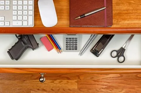 Personal weapon in work desk Stock Photos