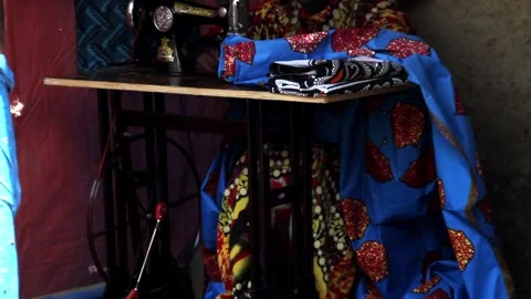 A person's bare foot rests on the treadle of a vintage manual sewing machine Stock Footage 345835604