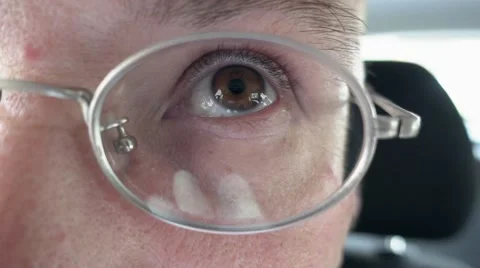 Person's brown eye through the metal glasses Stock Footage 68068848