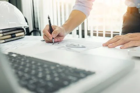 Person's engineer Hand Drawing Plan On Blue Print with architect equipment Fotos de archivo