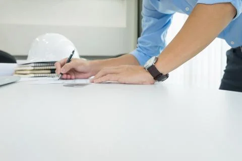 Person's engineer Hand Drawing Plan On Blue Print with architect equipment Stock Photos
