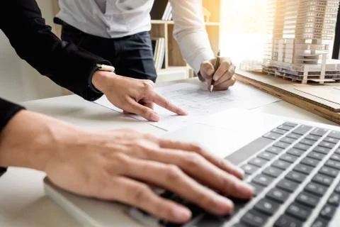 Person's engineer Hand Drawing Plan On Blue Print with architect equipment Fotos de archivo