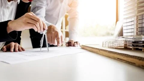 Person's engineer Hand Drawing Plan On Blue Print with architect equipment Fotos de archivo