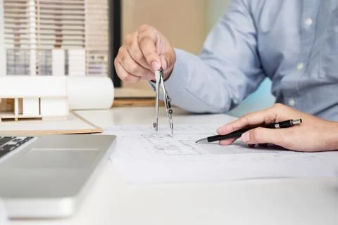 Person's engineer Hand Drawing Plan On Blue Print with architect equipment Fotos de archivo