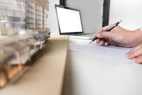 Person's engineer Hand Drawing Plan On Blue Print with architect equipment Fotos de archivo