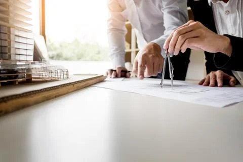 Person's engineer Hand Drawing Plan On Blue Print with architect equipment Fotos de archivo