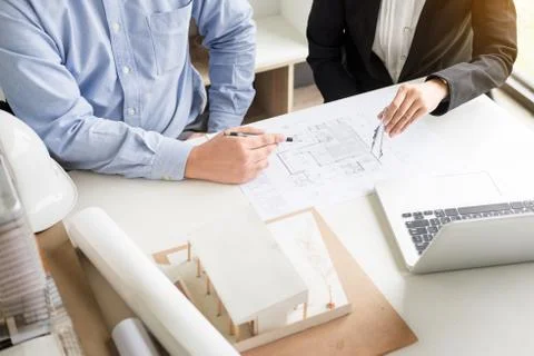 Person's engineer Hand Drawing Plan On Blue Print with architect equipment Fotos de archivo