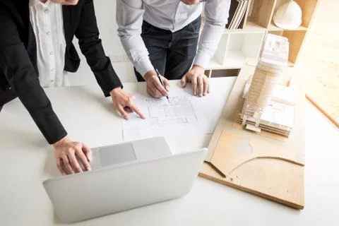 Person's engineer Hand Drawing Plan On Blue Print with architect equipment Fotos de archivo