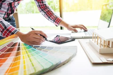 Person's engineer Hand Drawing Plan On Blue Print or working project in his o Fotos de archivo