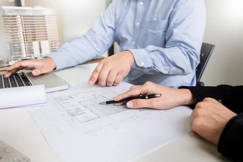 Person's engineer Hand Drawing Plan On Blue Print with architect equipment Fotos de archivo