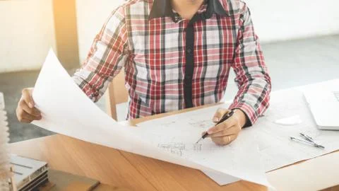 Person's engineer Hand Drawing Plan On Blue Print with architect equipment, A Stock Photos