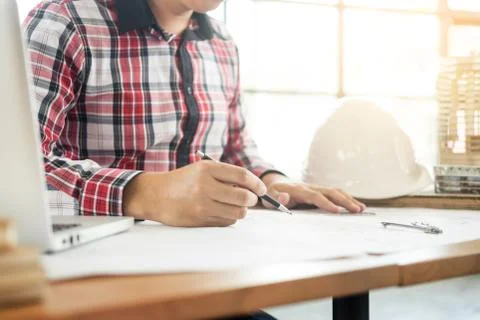 Person's engineer Hand Drawing Plan On Blue Print with architect equipment, A Stock Photos