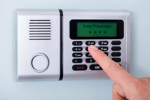Person's Finger Entering Code In Security System Stock Photos