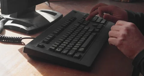 Persons finger pressing enter key repeatedly on computer keyboard Stock Footage 332634989