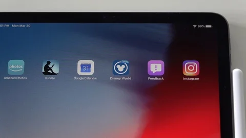 A person's finger selecting the Disney app on their iPad. Vídeo Stock 127390593