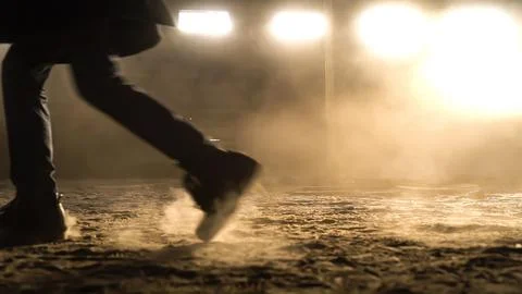 Person's foot steps in front of the camera and leaves dusty footprints Stock-Fotos